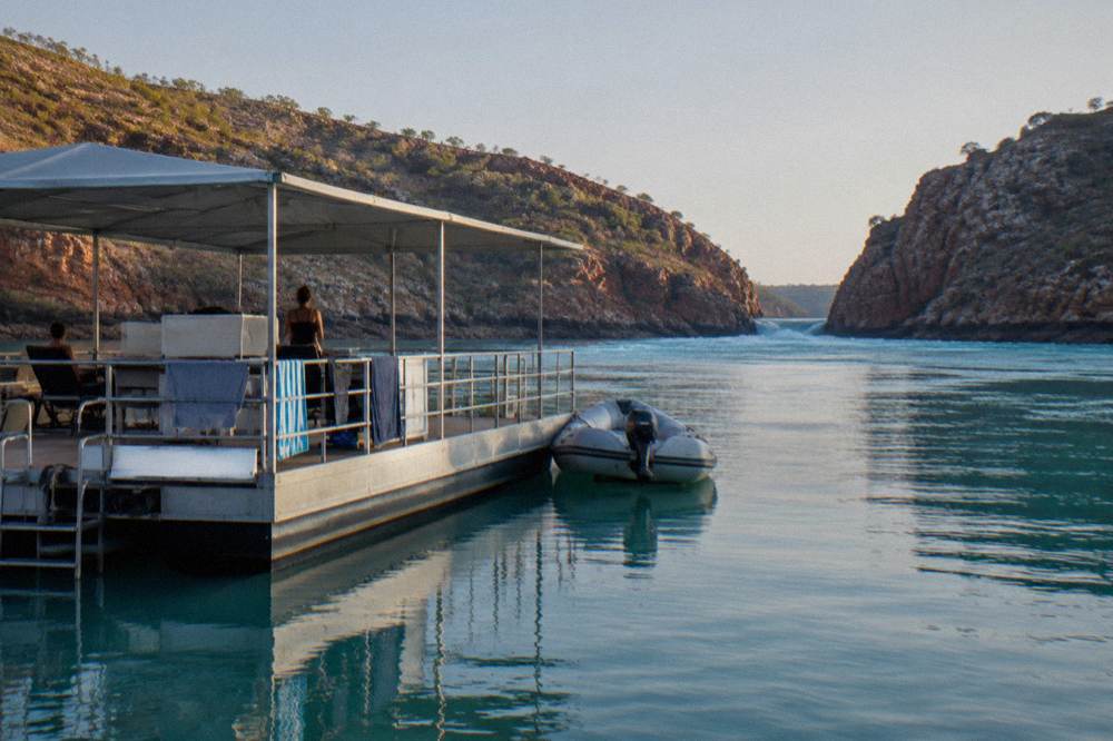 A floating pontoon with a sheltered deck on calm turquoise water