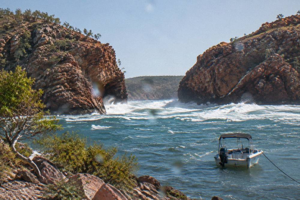 Turbulent tidal water rushing through a narrow rocky gap at Horizontal Falls