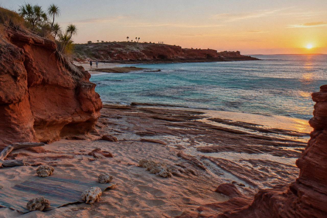 Red pindan cliffs and turquoise water at Gantheaume Point near Broome at sunset