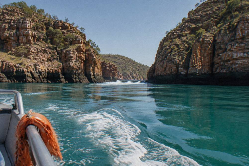 Turquoise water winding between steep rocky islands under a clear sky