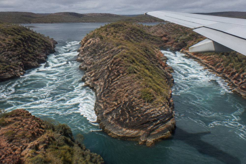 Two parallel channels of rough water separated by a ridge of dark rock