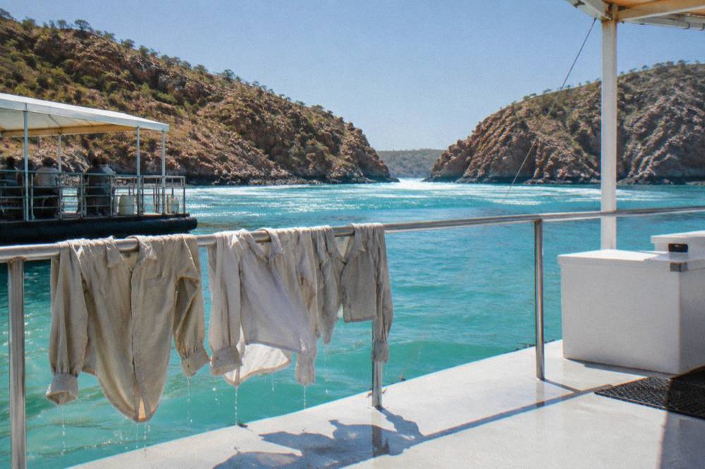 Light quick-dry clothing drying on a rail in tropical morning sun