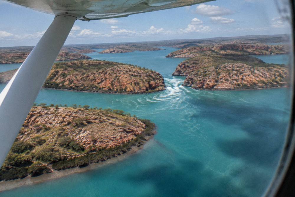 Turquoise water and red rock islands seen from the air over the Kimberley coast
